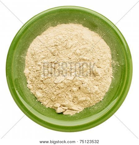 maca root powder in an isolated green ceramic bowl