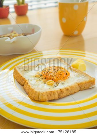 Breakfast . Fried egg on the toast.