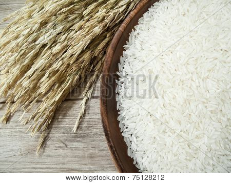 White Rice On The Wooden Plate And Rice Plant