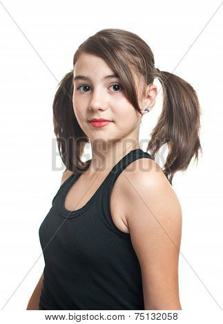 A beautiful teen girl in black top with pigtails. Portrait of smiling girl with two pigtails