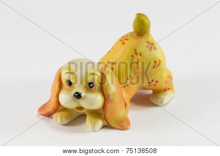 Statuette Of Dog Sitting On White Background