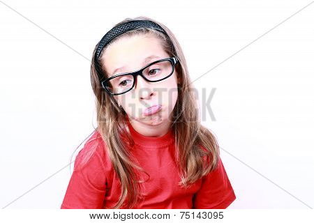 Thinking kid girl in glasses looking surly.