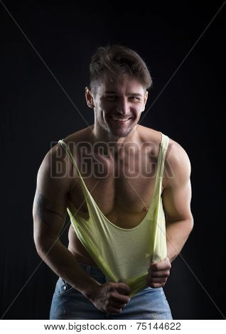 Young Athletic Man Pulling Down Tanktop On Ripped Muscular Torso