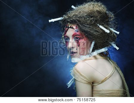 Young woman with creative make up. Halloween theme. Zombie theme.