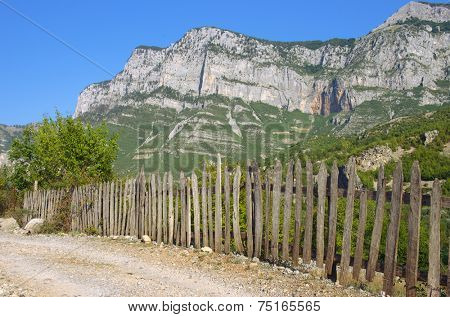 typical picket fence along a road of the Kelmend district between the Albanian Alps