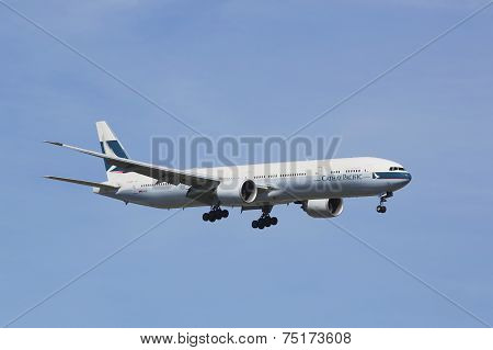 Cathay Pacific Boeing 777 in New York sky before landing at JFK Airport