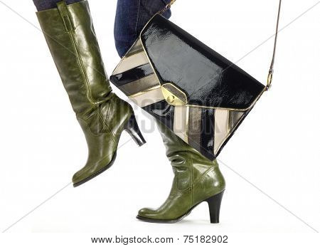 woman in fashion boots and trendy bag steps