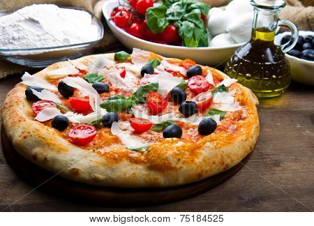 delicoius fresh pizza with tomatoes, olives and basil