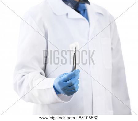 Doctor holding metal forceps with cheesecloth isolated on white background