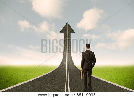 Businessman lokking at 3d road upgoing arrow concept