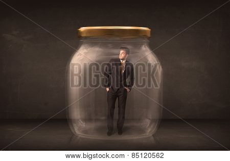 Businessman shut into a glass jar concept on background