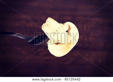 One sliced mashroom on a fork. 