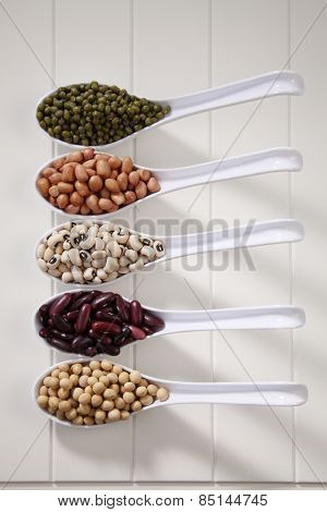 variety of beans group in five spoons
