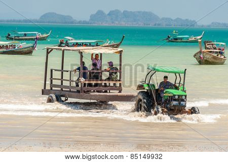 RAILAY, THAILAND - MARCH 13, 2014: Toutrists transport from mainland by boats to East Railay beach, one of the most popular rock climbing locations in Asia. on March 13, 2014. Railay, Krabi, Thailand
