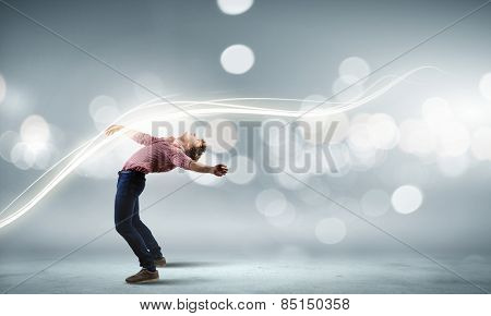 Young guy in casual evading from light rays