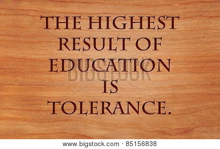 The highest result of education is tolerance - quote by Helen Keller on wooden red oak background
