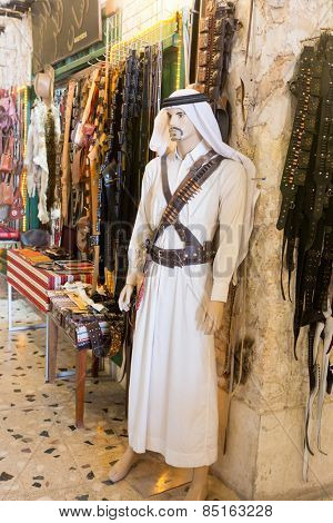 DOHA, QATAR - MARCH 8, 2015: Mannequin of a Qatari bedoin warrior outside a souvenir shop in Souq Waqif, Doha.