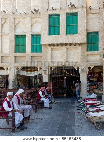 DOHA, QATAR - MARCH 8, 2015: Porters with their barrows await work outside part of the imposing Souq Waqif tourist attraction