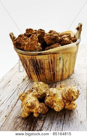 Fresh organic topinambur on wooden background, Jerusalem artichoke
