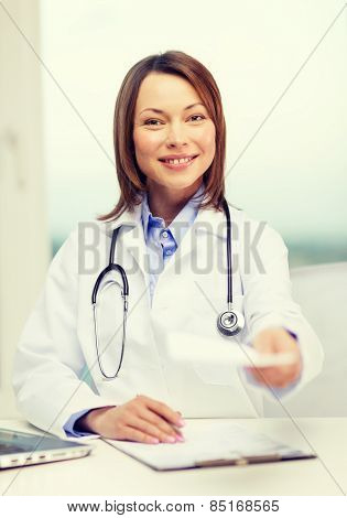 medicine and healthcare concept - smiling doctor with laptop computer