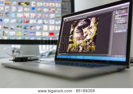 Photographers computer with photo edit apps/programs running 