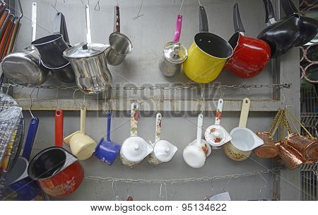 Metal finjans and pots in market stall