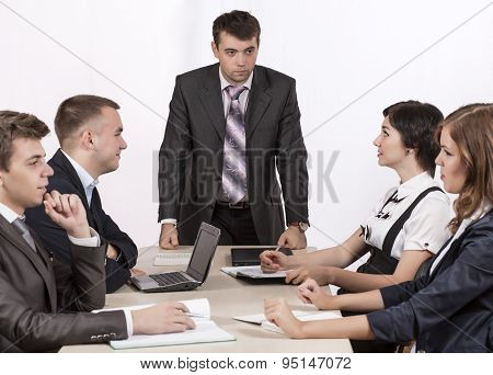 Severe corporate manager is observing his business team