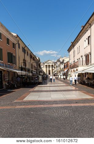 BARDOLINO, ITALY - MAY 4, 2016: Bardolino attractive old town on the Veronese shore of Lake Garda. Its downtown is lined with shops bars restaurants and pizzerias.