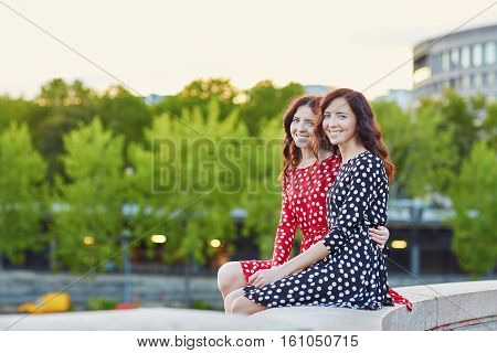 Beautiful Twin Sisters On The Bir Hakeim Bridge In Paris, France