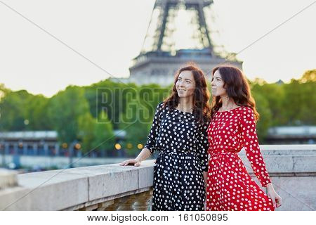Beautiful Twin Sisters In Front Of The Eiffel Tower In Paris