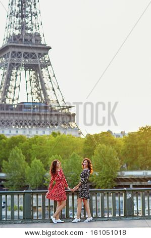 Beautiful Twin Sisters In Front Of The Eiffel Tower In Paris