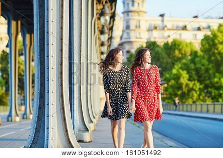 Beautiful Twin Sisters On The Bir Hakeim Bridge In Paris, France