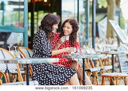 Beautiful Twin Sisters Drinking Coffee