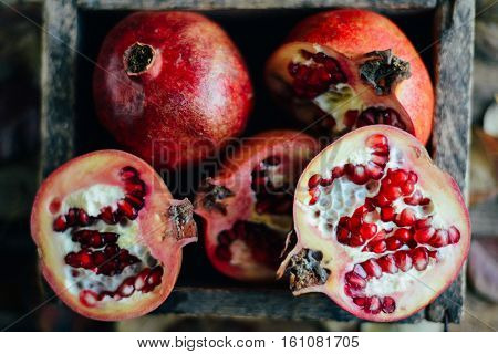 Ripe Pomegranate Fruit On Wooden Vintage Background. Red Juice P