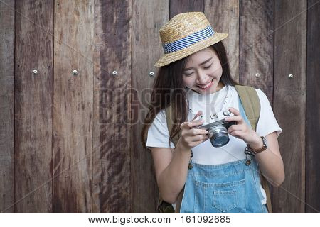 Young asian butiful woman with camera. in a blue shirt. Hipster fashion photographer girl. Young people vintage tone.