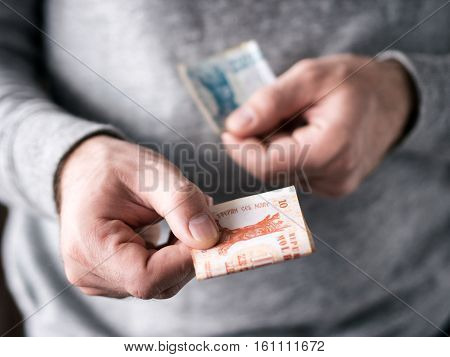 Hands Hold Moldovan Leu
