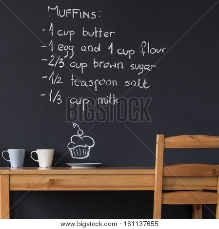 Table And Chairs Against Blackboard Wall