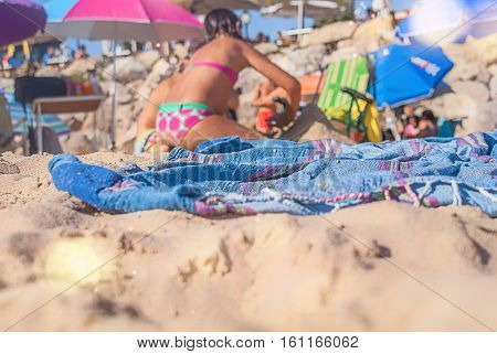 beautiful blanket on the sand and children play
