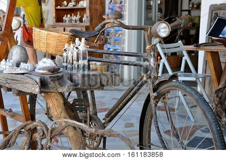 SANTORINI GREECE - SEPTEMBER 14, 2013: Old retro bicycle and vintage souvenirs in Oia santorini Greece