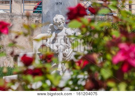 NOTO ITALY - SEPTEMBER 14 2015: Sculpture of an angel on a street in the old city center in Noto Sicily Italy.