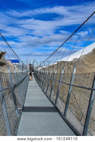 Mt. Titlis, Switzerland - 12 October, 2015: the Titlis Cliff Walk suspension bridge. The Titlis Cliff Walk is a pedestrian suspension bridge along the cliff of Mount Titlis in the Swiss Alps.