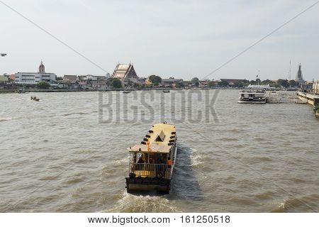 BANGKOK THAILAND - NOV 22 : small ferryboat in chao phraya river near Memorial Brigde on november 22 2016 thailand. chao phraya river is famous sightseeing route of Bangkok