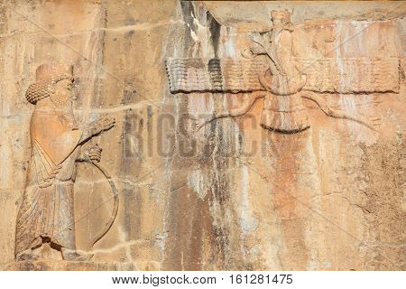 Faravahar - relief of winged sun symbol of Zoroastrianism in ruined Persepolis city