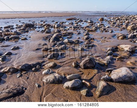 Pebbles and rocks on the beach at Ynyslas near Borth Ceredigion.