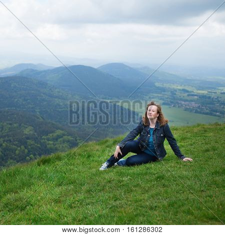 Girl Sitting On The Slope Of Volcano In Auvergne