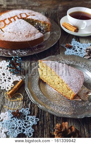 Homemade spiced Christmas sponge cake and crocheted snowflakes