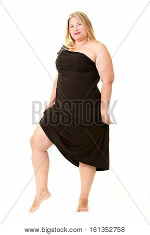 Attractive overweight woman in black evening dress full length on white