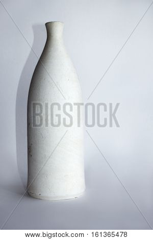 clay white bottle isolated on a gray background