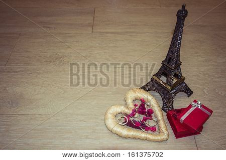 Background for Valentine's Day with heart, red gifts, toy Eiffel Tower