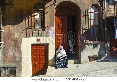 Istanbul Turkey - January 19 2014: Old buildings and local people in Tarlabasi. The district is a region inhabited by people belonging to a relatively low income level. Tarlabasi is a neighbourhood in the Beyoglu district in Istanbul. Tarlabasi through re